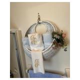 Master bathroom contents - towels, wicker hanger,