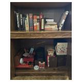 Shelf grouping books, cards, board games (some in