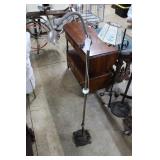 Cast metal floor lamp with green glass