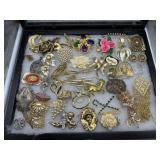Large costume grouping of brooches, pendants, and