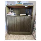 slider door side table in green hue with contents