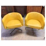 Pair yellow swivel MCM bucket armchairs *tear to f