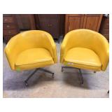 Pair yellow swivel MCM bucket armchairs *tear to f