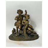 GILT METAL STATUE DEPICTING TWO CHILDREN ON ROCKS