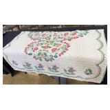 Single Cross-stitched quilt in red, green, and blu