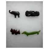 Four bakelite tokens- scotties, elephant, dauschun