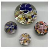 Four contemporary art glass floral paperweights in