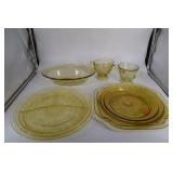 Eleven amber depression plates, bowls, covered jar