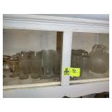 GROUP OF ASSORTED GLASSWARE ABOVE STOVE
