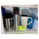 SHELF WITH MISC COFFEE MUGS AND PLASTIC TUMBLERS