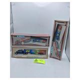 PAIR OF ERTL REPLICAS RACING TRANSPORTERS PAST AND