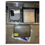 CONTENTS OF BOTTOM DRAWER IN STOVE, BAKING PANS, E
