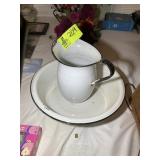 AN ENAMEL COATED PITCHER AND WASH PAN