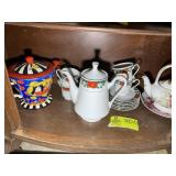 BOTTOM SHELF OF CURIO CABINET CHRISTMAS THEMED TEA