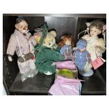 3RD SHELF WITH MISC DOLLS, CLOWN FIGURINE AND STUF
