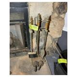 BRASS COLORED FIREPLACE SET AND CAST IRON IRONS