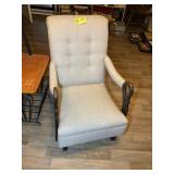 AN UPHOLSTERED ROCKING CHAIR