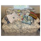 FLORAL UPHOLSTERED LOVESEAT WITH DECORATIVE PILLOW