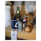 GROUP OF OIL CANS AND SODA BOTTLE