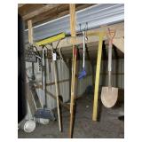 GROUP OF MISCELLANEOUS HAND TOOLS HANGING IN BUILD