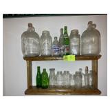 GROUP OF GLASS BOTTLES, JARS, JUGS ON SHELF
