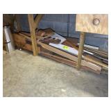 GROUP OF SCRAP WOOD UNDER WORK BENCH IN WORK ROOM