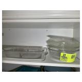 TOP SHELF OF CABINET INCLUDING CLEAR BAKING DISHES