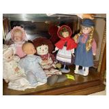 BOTTOM SHELF OF DOLLS, RAGGEDY ANN, ETC