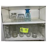 TWO SHELVES OF DRINKING GLASSES