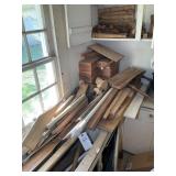 LARGE GROUP OF WOOD IN CORNER OF WORK SHOP
