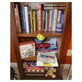BOTTOM THREE SHELVES INCLUDING, BOOKS, TOYS AND GA