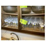 BOTTOM SHELF WITH GOOSE THEMED DRINKING GLASSES