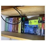 TOP SHELF OF CLOSET GROUP OF DVDS, HIGHLANDER, HER