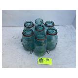 GROUP OF SEVEN BLUE GLASS BALL JARS IN METAL CARRI