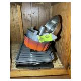 CONTENTS OF CABINET LEFT OF SINK, BAKING PANS, BUN