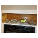GROUP OF GLASS SERVING DISHES ABOVE MICROWAVE