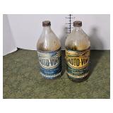 Two vintage Moto-Vim bottles