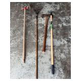 Lot of Garden Tools Including Rakes, Axe, and Cultivator