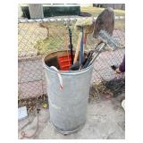 Large drum filled with yard tools
