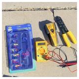 Voltmeter, stud finder, wire snips and terminal