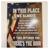 Metal wall sign in this place we always salute