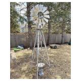 8 foot tall windmill with birdbath in the center