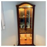 Lighted corner curio cabinet with glass shelves