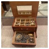 Vintage wooden jewelry box filled with jewelry