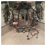Metal earring holder with earrings and angel