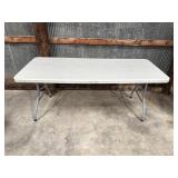 6 foot plastic folding table, one leg is a little