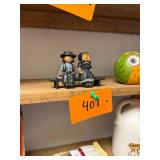 Vintage cast iron Amish man + woman on a bench