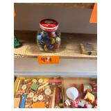 Vintage jar of wood game pieces and marbles