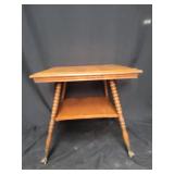 Wood table with lower shelf and claw feet
