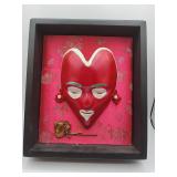 Framed red heart-shaped mask art